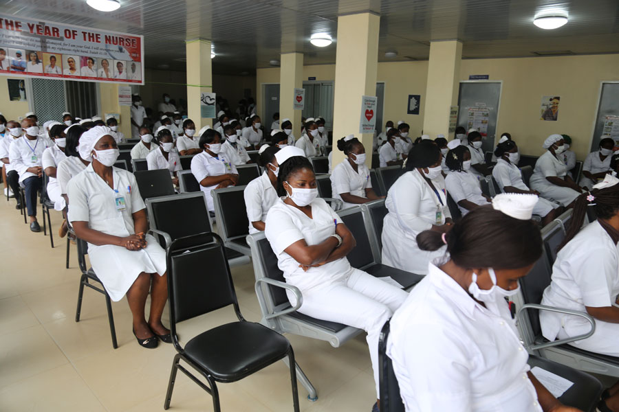 Cameroonian nursing students in white uniforms in a lecture hall